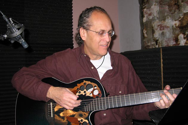 Pili playing guitar in recording studio